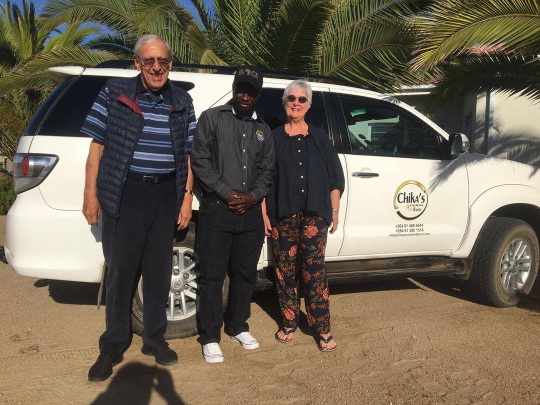 Guests and guide with a Chika's Fortuner tour vehicle